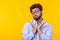 Young doubting mixed race male student with glasses and formal clothes posing on a yellow background with copy space