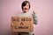 Young down syndrome woman holding protest banner we need a change from political problems screaming proud and celebrating victory