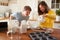 Young Downs Syndrome Couple Baking In Kitchen At Home