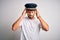 Young driver man with beard wearing hat standing over isolated white background suffering from headache desperate and stressed