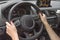 Young driver woman holding car wheel ready for journey