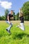 Young dutch couple jumping in green meadow