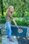 Young dutch woman beating door mat with carpet beater