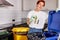 young eco-friendly female throw the tin can in trash can, side view portrait