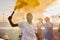 Young ecstatic African man with yellow smoke cracker