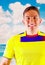 Young ecuadorian man wearing official Marathon football shirt standing facing camera, very engaged body language