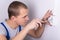 Young electrician installing electrical socket on wall