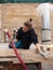 Young electrician lying on the ground assembling the and holding a red tube