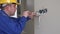 Young electrician at work with wall outlet and screwdriver installing sockets