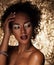 Young elegant african american woman with afro hair. Glamour makeup. Golden Background.