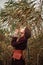 Young elegant lady on background of a reed field, portrait of fashionable girl posing in nature