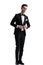 Young elegant man in tuxedo arranging coat and looking to side