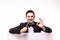 Young elegant talking man holding microphone talking on table with hands sign.