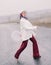 Young elegant woman poses on highway in countryside