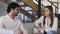 Young elegantly dressed couple sitting on a white sofa and talking.