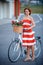 Young elegantly dressed woman with bicycle and a