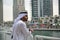 Young Emirati arab man standing by the canal