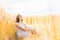 Young, emotional and happy woman in a meadow of rye