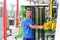 Young employee in a company manufacturing safety glass for house construction - works with a lifting tool