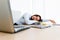 Young employee sleeps at workplace