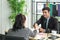 Young employers shaking hands during a meeting in the office