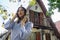 young empowered latin woman posing in front of her new chalet style house