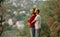 Young enamored couple stands and embraces on rest in forest.