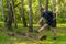 A young enduring athletic athlete is doing stretching in the forest outdoors, around the forest, oak trees.active nature