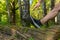 A young enduring athletic athlete is doing stretching in the forest outdoors, around the forest, oak trees. athlete