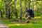 A young enduring athletic athlete is doing stretching in the forest outdoors, around the forest, oak trees.run sport