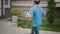 A young and energetic delivery man, carrying a pizza and a bag of groceries. The man is doing his job.