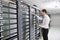 Young engeneer in datacenter server room