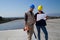 Young engineer girl and skilled worker on a roof