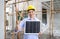 Young engineer in hardhat lift finger thumb up while holding solar cell panel, present a source of energy to generate direct