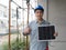 Young engineer in hardhat and walkie talkie lift finger thumbs up while holding solar cell panel, present a source of energy to