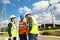 Young engineers and workers having a meeting at wind farm