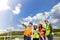 Young engineers and workers having a meeting at wind farm