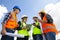 Young engineers and workers having a meeting at wind farm