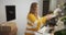 Young entrepreneur woman sorting boxes with goods in kitchen, businesswoman starting small business at home