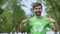 Young environmental activist pointing at recycling symbol t-shirt, segregation