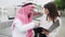 Young european business woman yacht broker showing contract details to Arab man client in port