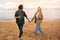 Young european couple sipping wine while walking on the beach,