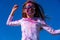 Young european girl celebrating holy festival on a blue sky background