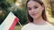 A young European lady is waving the Hungarian flag