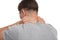 Young european man suffering from neck pain and pressing hand to sore spot