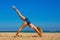 Young european woman exercising on egyptian beach