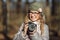 Young european woman photographer enjoying first spring sun exploring suburban locations