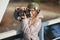 Young european woman photographer enjoying first spring sun exploring suburban locations railway bridge