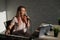 A young European woman sings into a microphone and accompanies on an electronic piano. The girl shoots a video blog