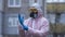 The young europeans man in protective chemical suit and respirator, outdoors. New coronavirus COVID-19